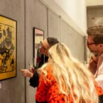 Guests contemplating works